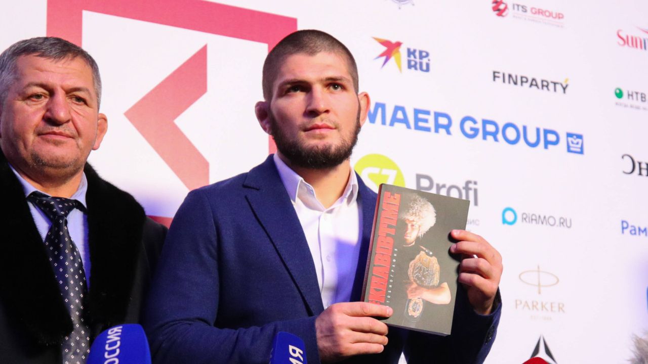 Coach Abdulmanap Nurmagomedov and Russian mixed martial artist, UFC lightweight champion Khabib Nurmagomedov during a press approach after an interview at the Synergy Global Forum business forum at the Olympic Sports Complex in Moscow.
