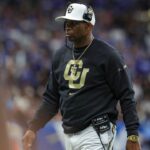 Dec 28, 2024; San Antonio, TX, USA; Colorado Buffaloes head coach Deion Sanders walks on the field during the game against the Brigham Young Cougars at Alamodome.