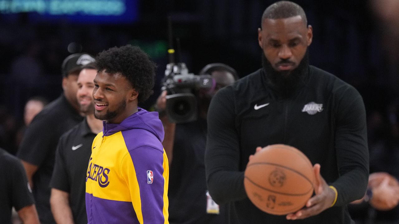 Los Angeles Lakers guard Bronny James (left) and father LeBron James during the game against the Memphis Grizzlies at Crypto.com Arena.