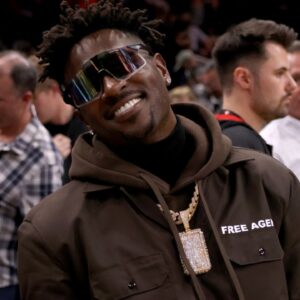 Former Tampa Bay Buccaneers wide receiver Antonio Brown poses for photographers after the game between the Atlanta Hawks and the LA Clippers at State Farm Arena.