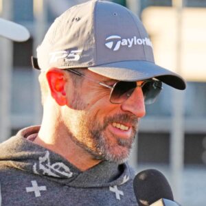 FeJets quarterback Aaron Rodgers talks with the press on the first tee box during the Phoenix Open Annexus Pro-Am at TPC Scottsdale.