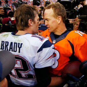 Denver Broncos quarterback Peyton Manning (18) greets New England Patriots quarterback Tom Brady (12) after the AFC Championship football game at Sports Authority Field at Mile High.