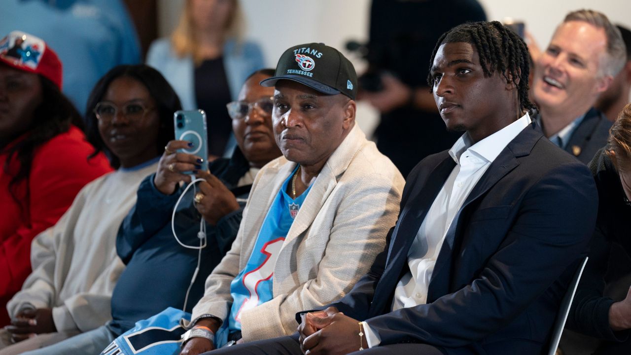 Cam Ward waits next to his father, Calvin Ward, center, to be introduced as the Tennessee Titans first-round pick – and overall number one pick – in the NFL Draft at Ascension Saint Thomas Sports Park in Nashville, Tenn., Friday, April 25, 2025