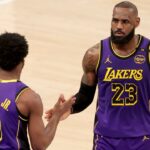 Los Angeles Lakers guard Bronny James (9) checks in for forward LeBron James (23) during the fourth quarter against the New York Knicks at Madison Square Garden