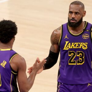 Los Angeles Lakers guard Bronny James (9) checks in for forward LeBron James (23) during the fourth quarter against the New York Knicks at Madison Square Garden