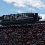 Spotters watch the race from atop the press box during the GEICO 500 at Talladega Superspeedway.