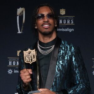 Washington Commanders quarterback Jayden Daniels poses with the Offensive Rookie of the Year award during Super Bowl LIX NFL Honors at Saenger Theatre.
