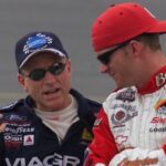 Mark Martin talks with Dale Earnhardt Jr. just before their qualifying runs were called off due to rain Friday afternoon, July 6, 2001 at the Daytona International Speedway.