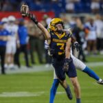 December 17, 2024, Frisco, Texas, USA: West VirginiaÃ¢â‚¬â ¢s HUDSON CLEMENT (3) reaches for a pass as Memphis TigersÃ¢â‚¬â ¢ KOBEE MINOR (7) defends during the Scooter Coffee Frisco Bowl at Toyota Stadium in Frisco on Tuesday night. Frisco USA - ZUMAm257 20241217_zsp_m257_012 Copyright: xBrianxMcLeanx