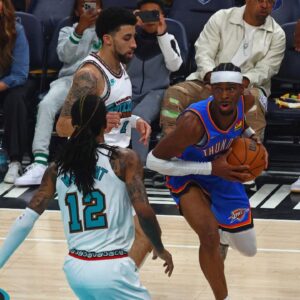 Oklahoma City Thunder guard Shai Gilgeous-Alexander (2) drives to the basket as Memphis Grizzlies guard Scotty Pippen Jr. (1) and guard Ja Morant (12) defend during the first quarter during game three for the first round of the 2024 NBA Playoffs at FedExForum
