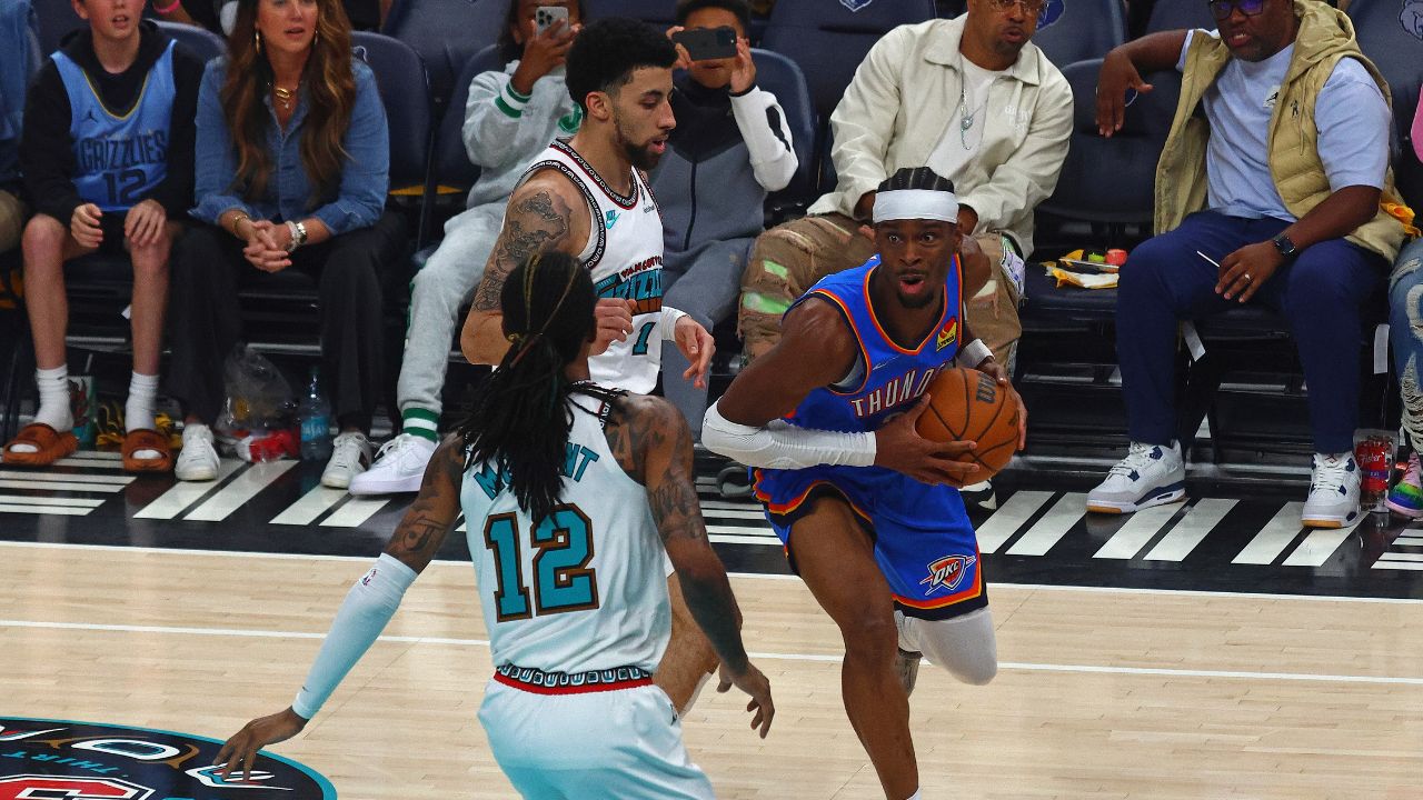 Oklahoma City Thunder guard Shai Gilgeous-Alexander (2) drives to the basket as Memphis Grizzlies guard Scotty Pippen Jr. (1) and guard Ja Morant (12) defend during the first quarter during game three for the first round of the 2024 NBA Playoffs at FedExForum