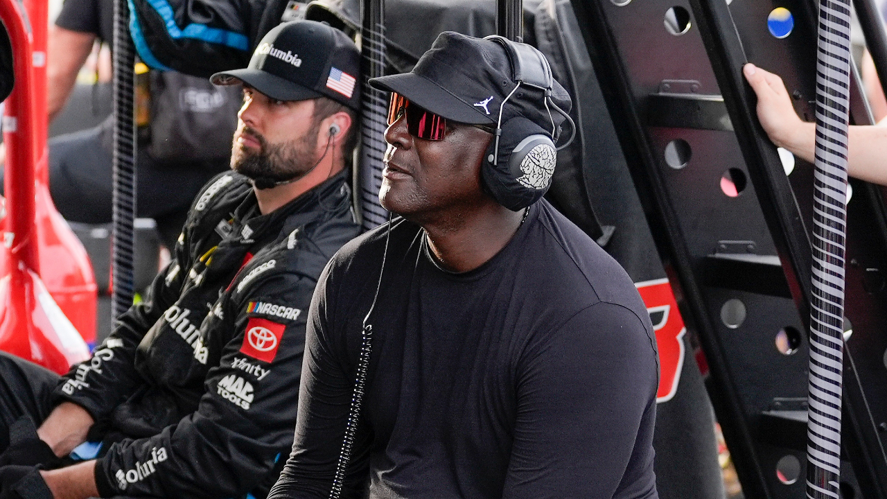 Apr 6, 2025; Darlington, South Carolina, USA; NASCAR Cup Series driver Tyler Reddick (45) team owner Michael Jordan watches his racer during the Goodyear 400 at Darlington Raceway. Mandatory Credit: Jim Dedmon-Imagn Images