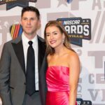 Denny Hamlin and Jordan Fish poses on the red carpet for the 2023 NASCAR Awards Banquet at the Music City Center in Nashville, Tenn.