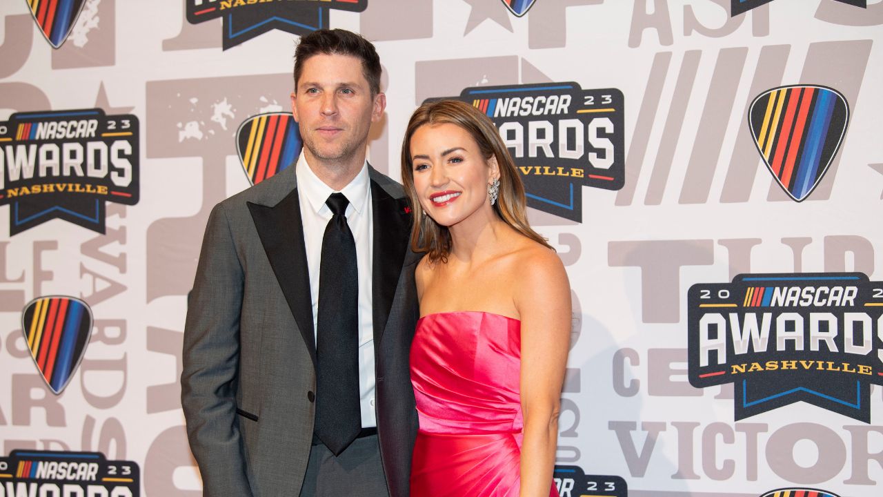 Denny Hamlin and Jordan Fish poses on the red carpet for the 2023 NASCAR Awards Banquet at the Music City Center in Nashville, Tenn.
