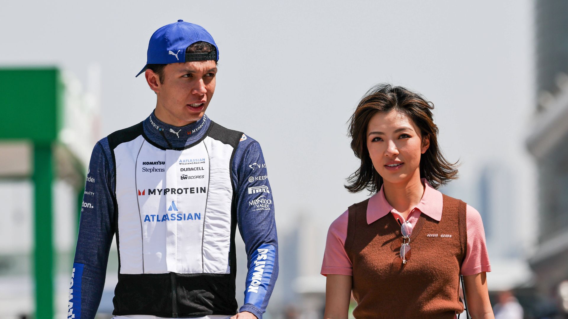 Alexander Albon of Thailand and Atlassian Williams Racing walks with his girl friend Lily He Muni in the paddock during Sprint ahead of the F1 Grand Prix of CHINA at Shanghai International Circuit
