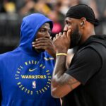 Golden State Warriors forward Draymond Green (23) and Los Angeles Lakers forward LeBron James (23) talk on court before warm up at T-Mobile Arena.