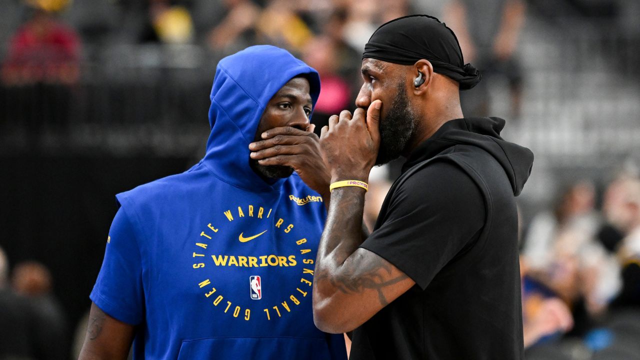 Golden State Warriors forward Draymond Green (23) and Los Angeles Lakers forward LeBron James (23) talk on court before warm up at T-Mobile Arena.