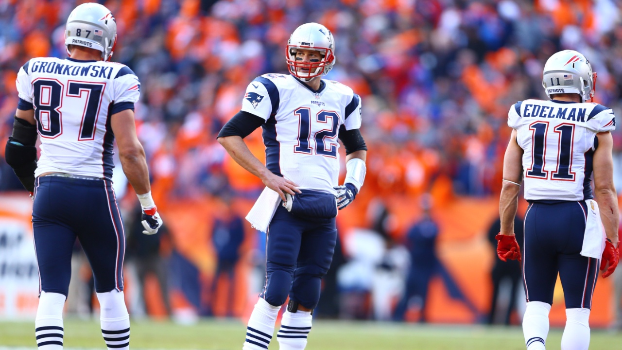 Jan 24, 2016; Denver, CO, USA; New England Patriots quarterback Tom Brady (12) with tight end Rob Gronkowski (87) and wide receiver Julian Edelman (11) against the Denver Broncos in the AFC Championship football game at Sports Authority Field at Mile High.