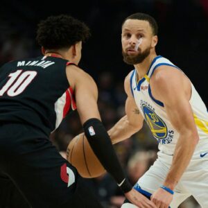 Golden State Warriors guard Stephen Curry (30) dribbles the ball during the first half against Portland Trail Blazers forward Justin Minaya (10) at Moda Center.