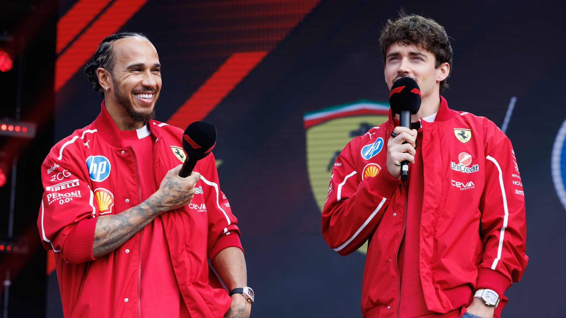 Lewis Hamilton of Great Britain (L) and Charles Leclerc of Monaco (R) and the Scuderia Ferrari HP Team seen at the fan forum ahead of the F1 Grand Prix of Australia