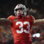 Ohio State Buckeyes defensive end Jack Sawyer (33) celebrates a sack of Tennessee Volunteers quarterback Nico Iamaleava (8) during the first half of the College Football Playoff first round game at Ohio Stadium in Columbus on Dec. 21, 2024.