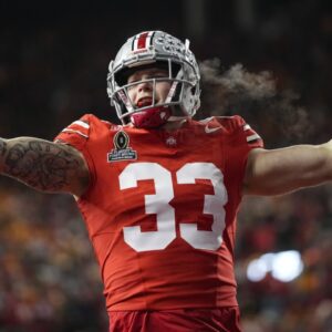 Ohio State Buckeyes defensive end Jack Sawyer (33) celebrates a sack of Tennessee Volunteers quarterback Nico Iamaleava (8) during the first half of the College Football Playoff first round game at Ohio Stadium in Columbus on Dec. 21, 2024.