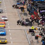 NASCAR cars come down pit road for service during the Cook Out 400 at Martinsville Speedway.