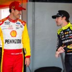 NASCAR Cup Series driver Joey Logano (left) talks with teammate Ryan Blaney during practice for the Daytona 500 at Daytona International Speedway.