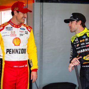 NASCAR Cup Series driver Joey Logano (left) talks with teammate Ryan Blaney during practice for the Daytona 500 at Daytona International Speedway.