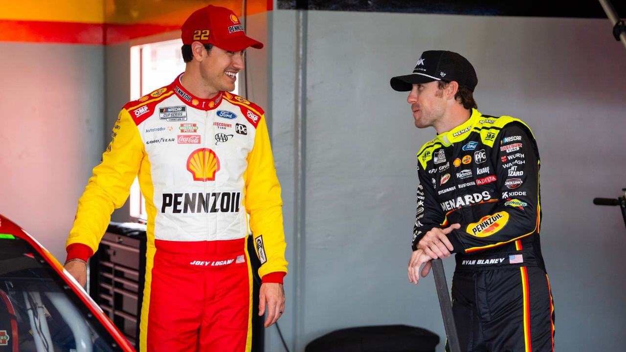 NASCAR Cup Series driver Joey Logano (left) talks with teammate Ryan Blaney during practice for the Daytona 500 at Daytona International Speedway.