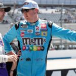 NASCAR Cup Series driver Kyle Busch (right) talks with driver Denny Hamlin (left) on pit road during qualifying for the DuraMAX Drydene 400 at Dover Motor Speedway.