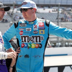 NASCAR Cup Series driver Kyle Busch (right) talks with driver Denny Hamlin (left) on pit road during qualifying for the DuraMAX Drydene 400 at Dover Motor Speedway.