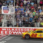 NASCAR Cup Series driver Joey Logano (22) takes the checkered flag during the All Star race at North Wilkesboro Speedway.