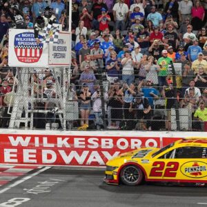 NASCAR Cup Series driver Joey Logano (22) takes the checkered flag during the All Star race at North Wilkesboro Speedway.