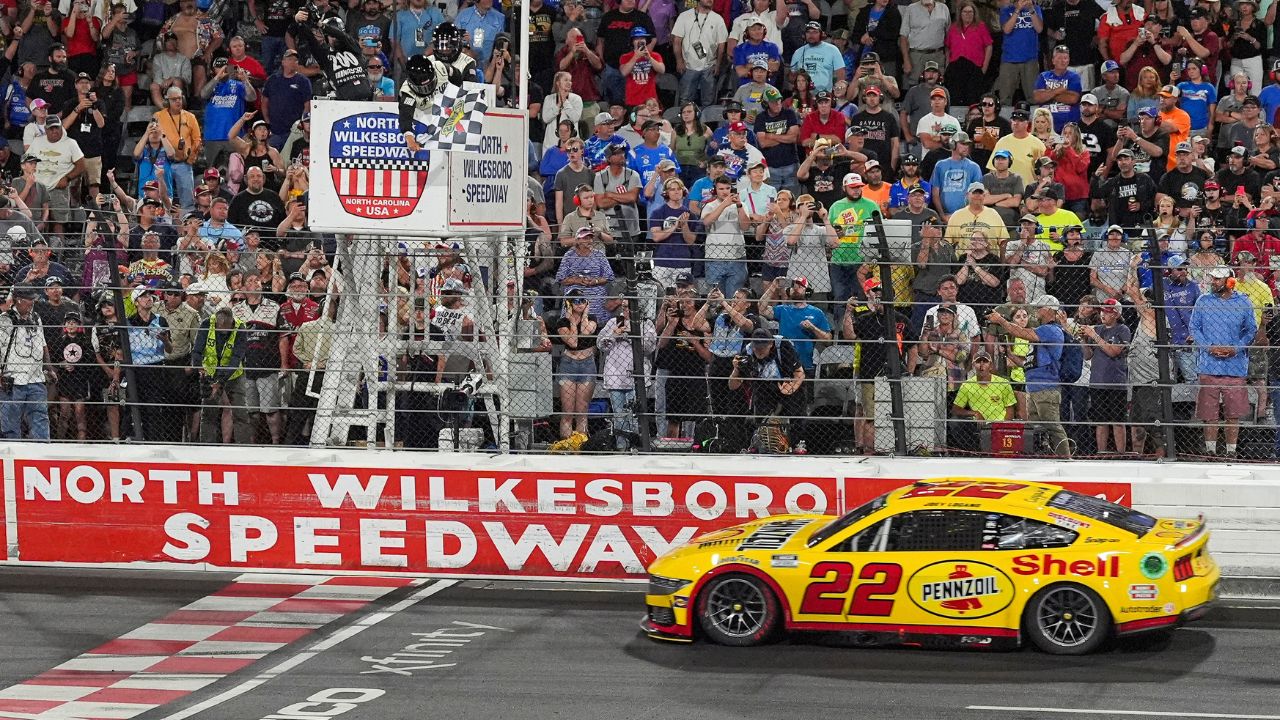 NASCAR Cup Series driver Joey Logano (22) takes the checkered flag during the All Star race at North Wilkesboro Speedway.