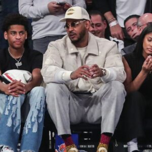 Former NBA player Carmelo Anthony (r) sits with his son Kiyan Anthony (l) at the game between the Boston Celtics and the New York Knicks at Madison Square Garden.