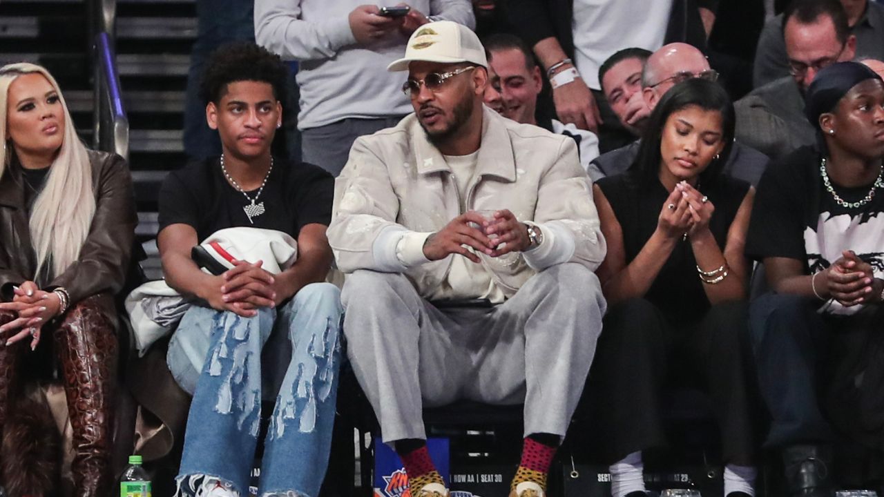 Former NBA player Carmelo Anthony (r) sits with his son Kiyan Anthony (l) at the game between the Boston Celtics and the New York Knicks at Madison Square Garden.