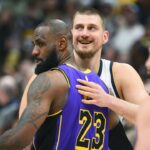 Denver Nuggets center Nikola Jokic (15) and Los Angeles Lakers forward LeBron James (23) hug before the game at Ball Arena