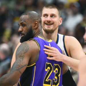 Denver Nuggets center Nikola Jokic (15) and Los Angeles Lakers forward LeBron James (23) hug before the game at Ball Arena