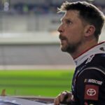 Denny Hamlin gets out of his car and checks out the screen during the Daytona 500 Pole Qualifying at Daytona International Speedway.