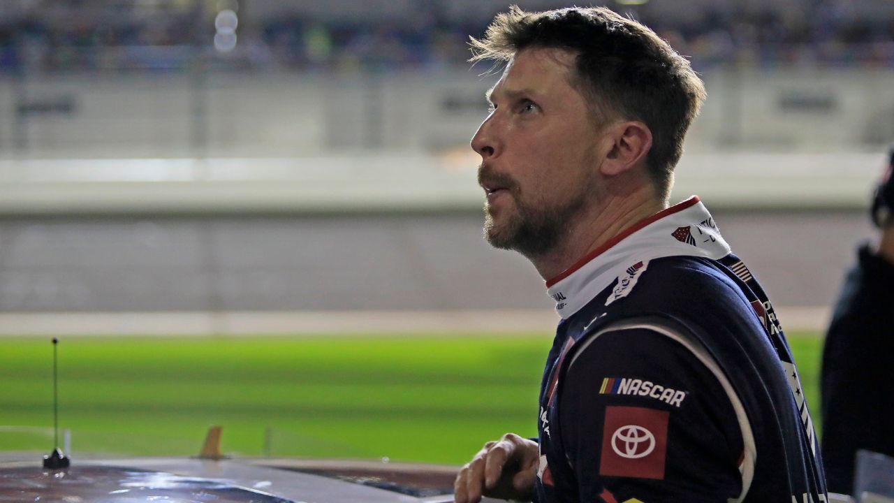 Denny Hamlin gets out of his car and checks out the screen during the Daytona 500 Pole Qualifying at Daytona International Speedway.