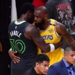 Minnesota Timberwolves forward Julius Randle (30) meets with Los Angeles Lakers forward LeBron James (23) following game five of first round for the 2025 NBA Playoffs at Crypto.com Arena