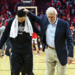 San Antonio Spurs guard Danny Green (14) and head coach Gregg Popovich (R) walk off the court after defeating the Houston Rockets in game six of the second round of the 2017 NBA Playoffs