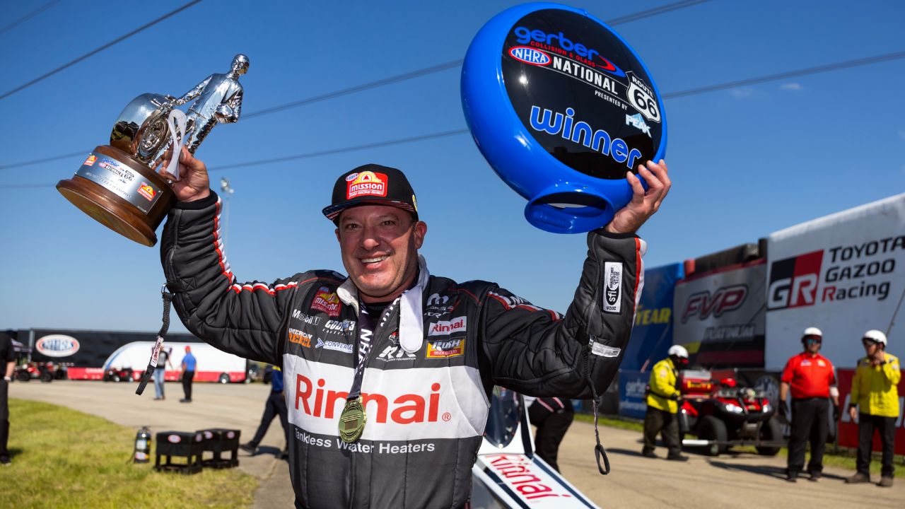 NHRA top fuel driver Tony Stewart celebrates after winning the Route 66 Nationals at Route 66 Raceway.