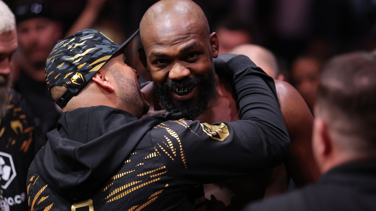 on Jones (red gloves) enters prior to fighting Stipe Miocoic (blue gloves) in the heavyweight bout during UFC 309 at Madison Square Garden.