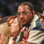 Oct 1, 2024; Brooklyn, New York, USA; Former NBA forward Carmelo Anthony and his son Kyian Anthony during game two of the 2024 WNBA Semi-finals at Barclays Center. Mandatory Credit: Wendell Cruz-Imagn Images