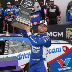 William Byron (17) hoists the trophy after his win during the Bet MGM 300 at Charlotte Motor Speedway.