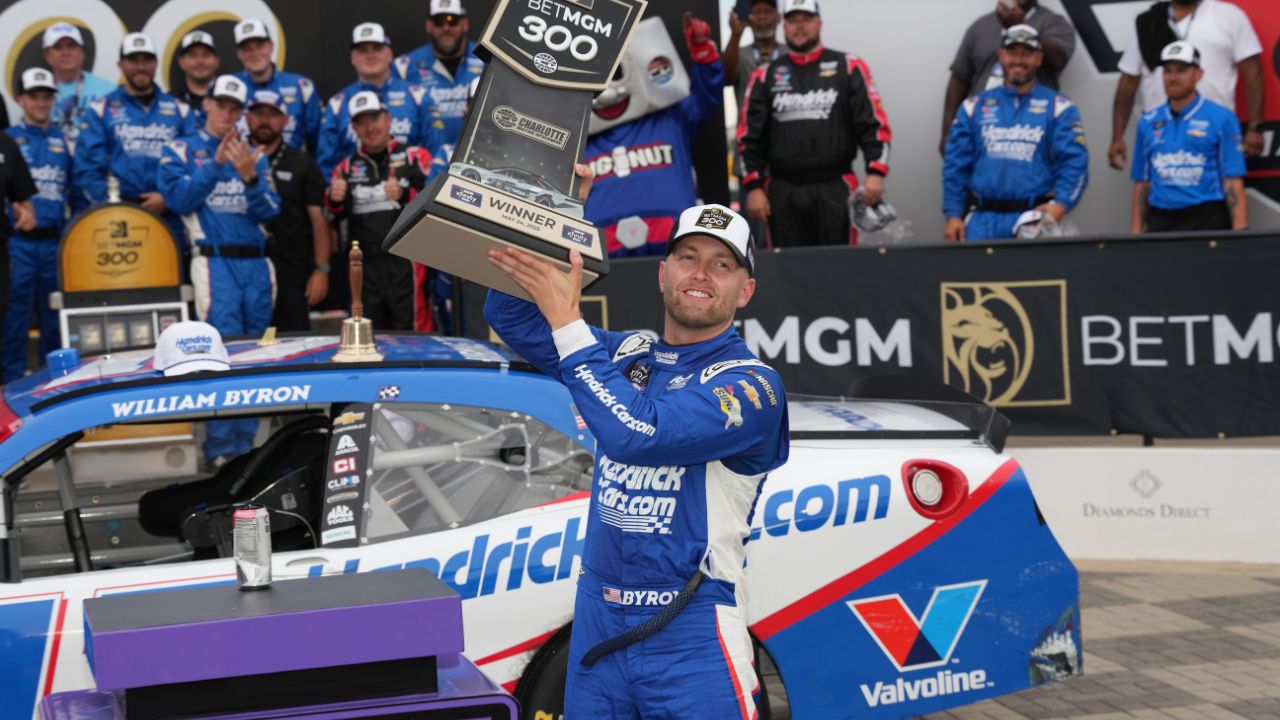 William Byron (17) hoists the trophy after his win during the Bet MGM 300 at Charlotte Motor Speedway.