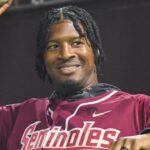Former Florida State quarterback and baseball player Jameis Winston warms up ahead of throwing the first pitch for a game on March 10, 2023.