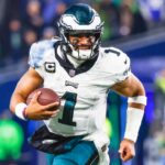 Dec 18, 2023; Seattle, Washington, USA; Philadelphia Eagles quarterback Jalen Hurts (1) rushes against the Seattle Seahawks during the second quarter at Lumen Field.